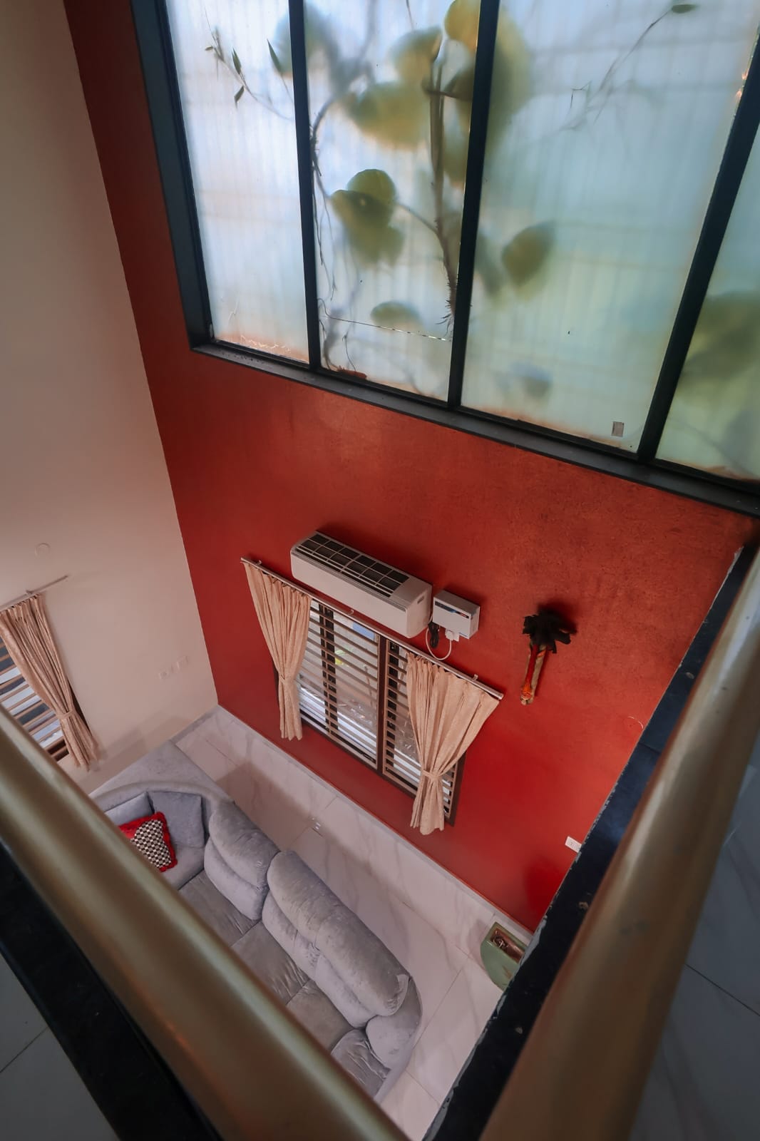 Mahesh House &mdash; double-height living room with terracotta accent wall